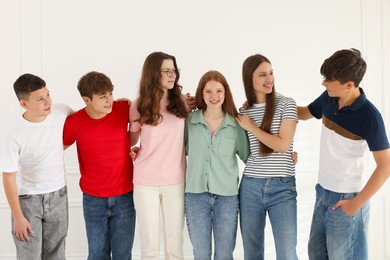Photo of Group of happy teenagers posing together indoors