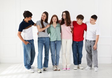 Photo of Group of happy teenagers posing together indoors