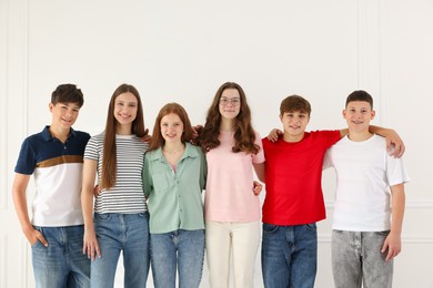 Photo of Group of happy teenagers posing together indoors