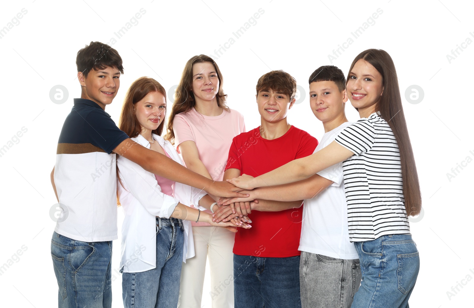 Group of happy teenagers joining hands on white background Photo of Group of happy teenagers joining hands on white background