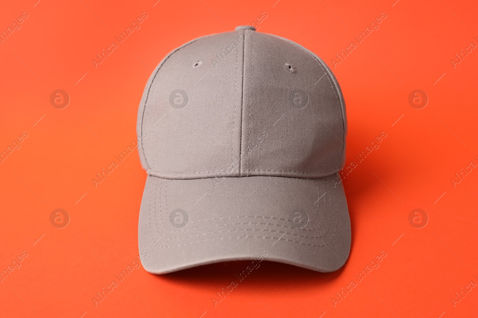 Beige baseball hat on orange background, closeup. Mockup for design Photo of Beige baseball hat on orange background, closeup. Mockup for design
