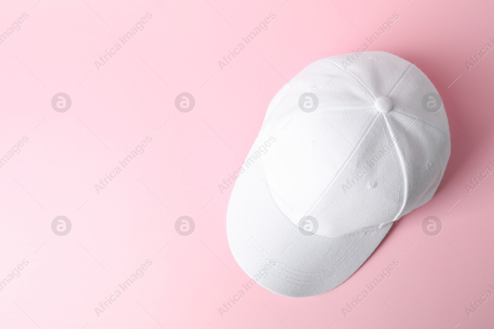 White baseball hat on pink background, top view. Space for text Photo of White baseball hat on pink background, top view. Space for text