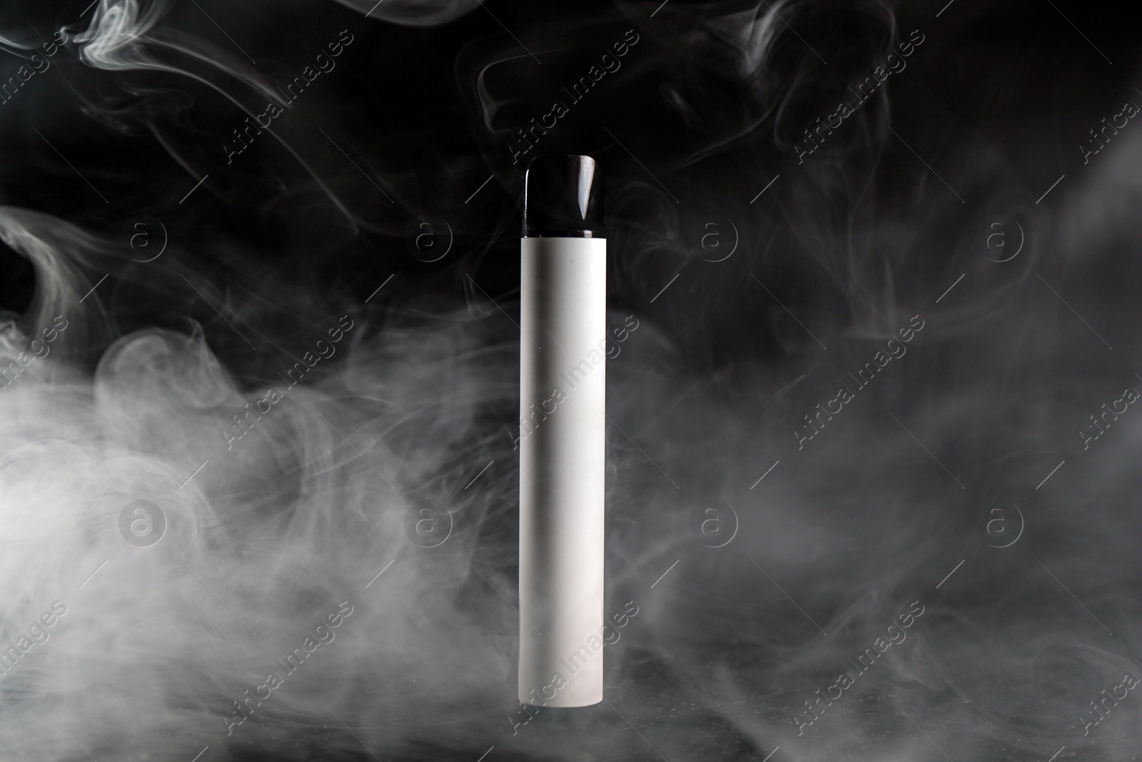Modern electronic smoking device on black table Photo of Modern electronic smoking device on black table
