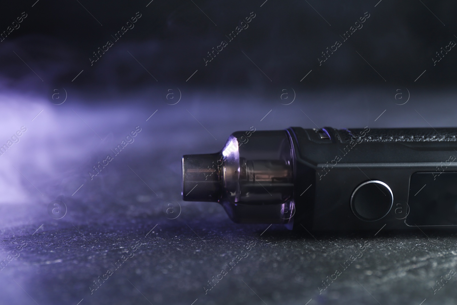 Modern electronic smoking device on black table, closeup. Space for text Photo of Modern electronic smoking device on black table, closeup. Space for text