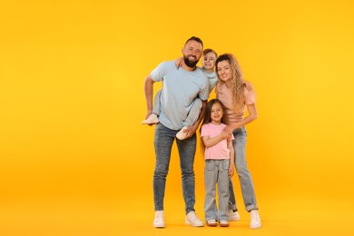 Photo of Happy family on yellow background. Space for text