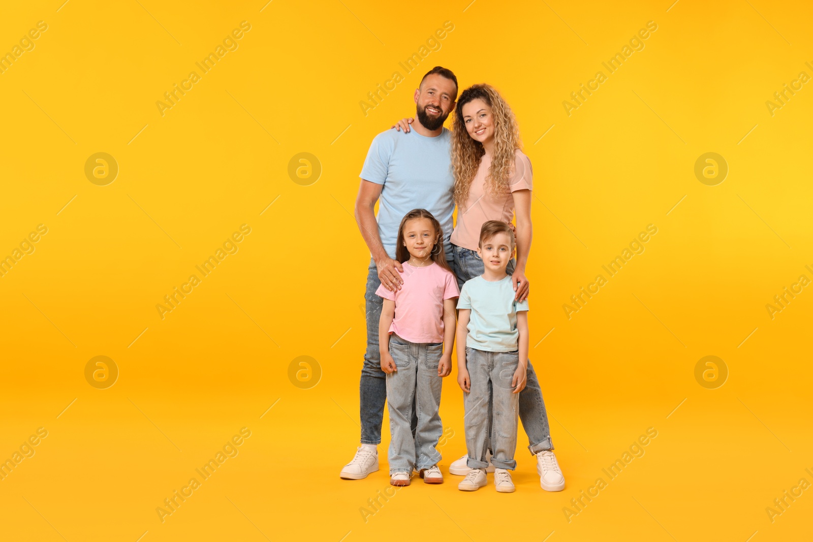 Photo of Happy family on yellow background. Space for text