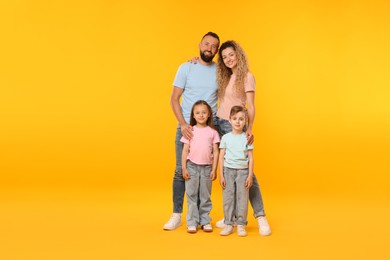 Photo of Happy family on yellow background. Space for text