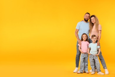 Photo of Happy family on yellow background. Space for text