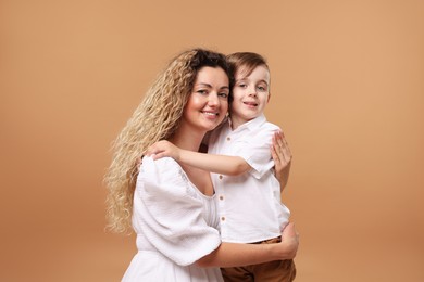Photo of Family. Happy mother and her son on beige background