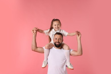 Photo of Family. Happy father and his daughter on pink background