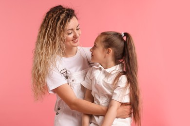 Photo of Family portrait of happy mother and her daughter on pink background