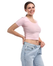 Photo of Beautiful woman wearing old jeans after weight loss on white background