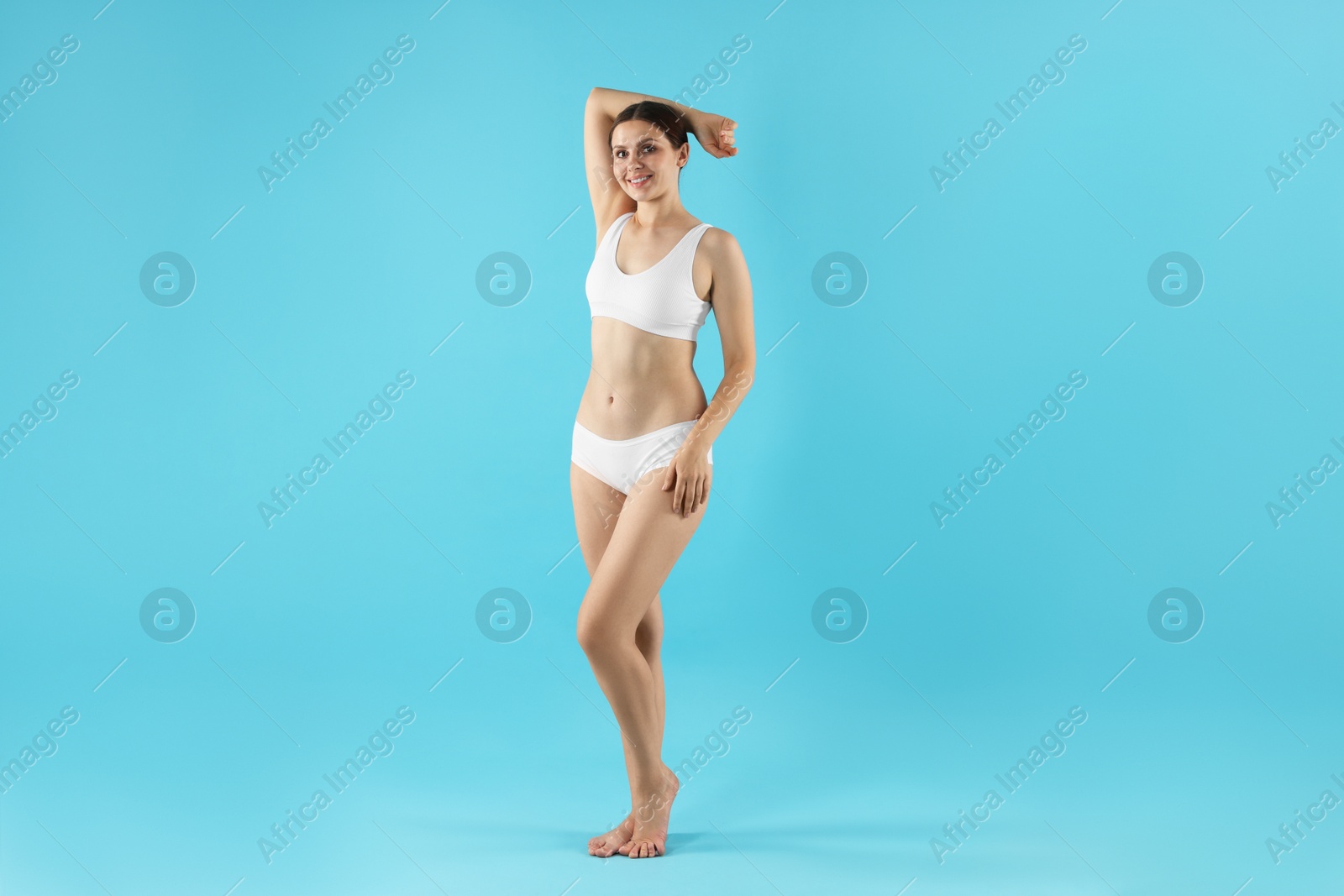 Photo of Beautiful woman in underwear on light blue background