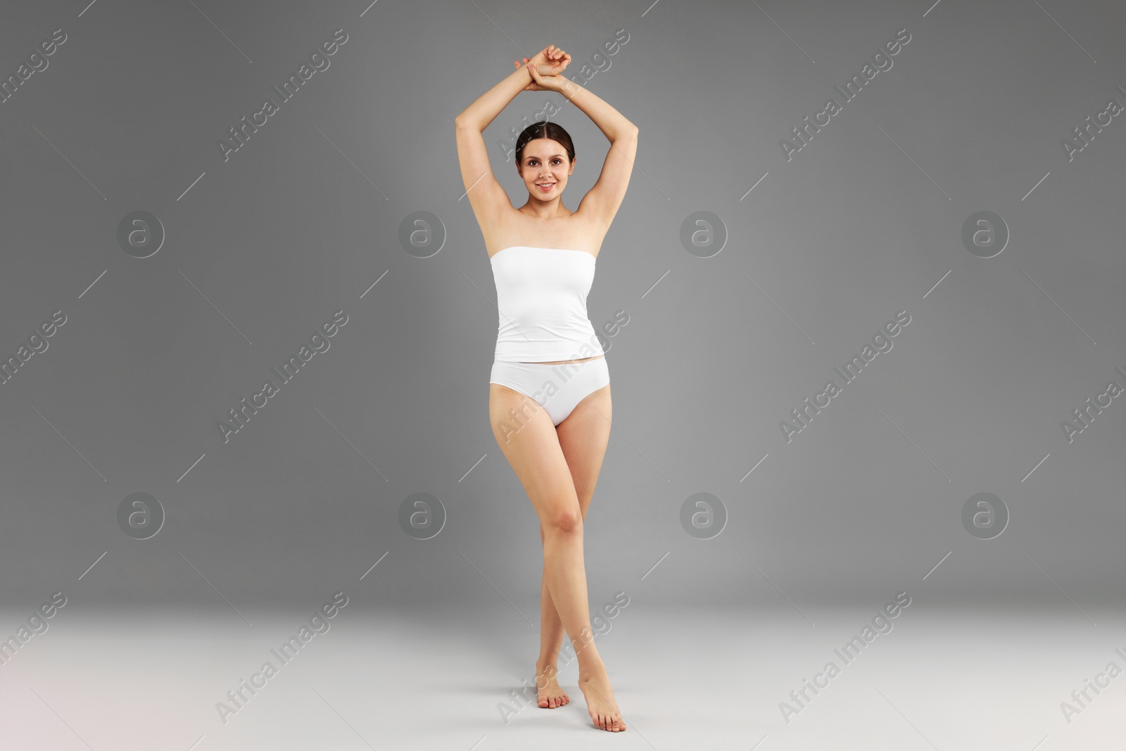 Beautiful woman in underwear on grey background Photo of Beautiful woman in underwear on grey background