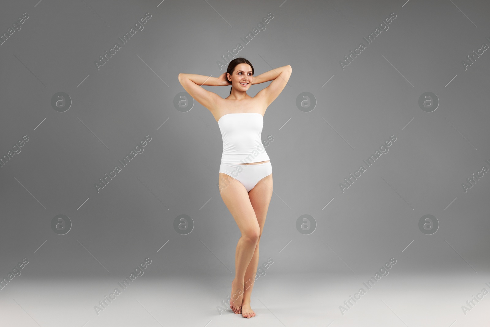 Beautiful woman in underwear on grey background Photo of Beautiful woman in underwear on grey background