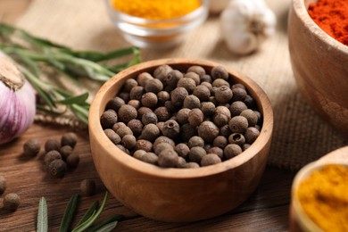 Photo of Different aromatic spices on wooden table, closeup