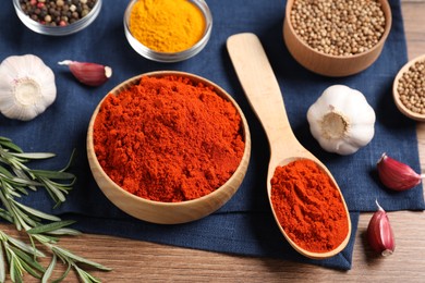 Photo of Different aromatic spices on wooden table, closeup