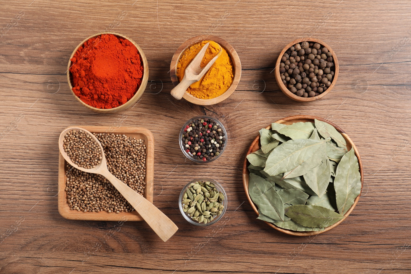 Different aromatic spices on wooden table, flat lay Photo of Different aromatic spices on wooden table, flat lay
