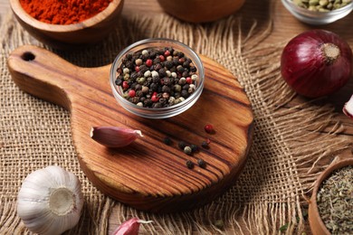 Photo of Different aromatic spices on wooden table, closeup