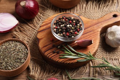 Photo of Different aromatic spices on wooden table, closeup