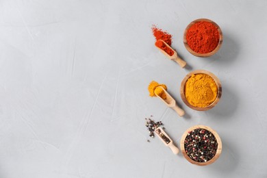 Photo of Different aromatic spices on light table, flat lay. Space for text