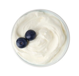 Photo of Delicious yogurt with blueberries in bowl isolated on white, top view