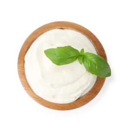Photo of Delicious yogurt with basil in bowl isolated on white, top view