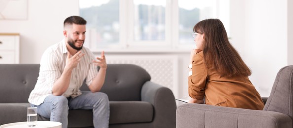 Photo of Professional psychologist working with patient in office, selective focus