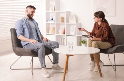 Photo of Professional psychologist working with patient in office