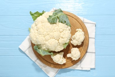Photo of Raw cauliflower on light blue wooden table, top view