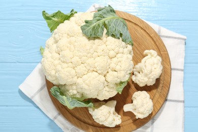 Photo of Raw cauliflower on light blue wooden table, top view