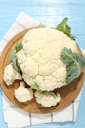 Photo of Raw cauliflower on light blue wooden table, top view