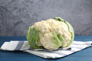 Photo of Whole raw cauliflower on blue wooden table