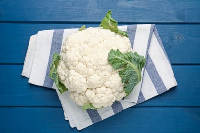 Photo of Whole cauliflower on blue wooden table, top view