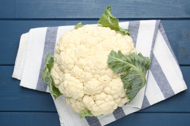 Photo of Whole cauliflower on blue wooden table, top view