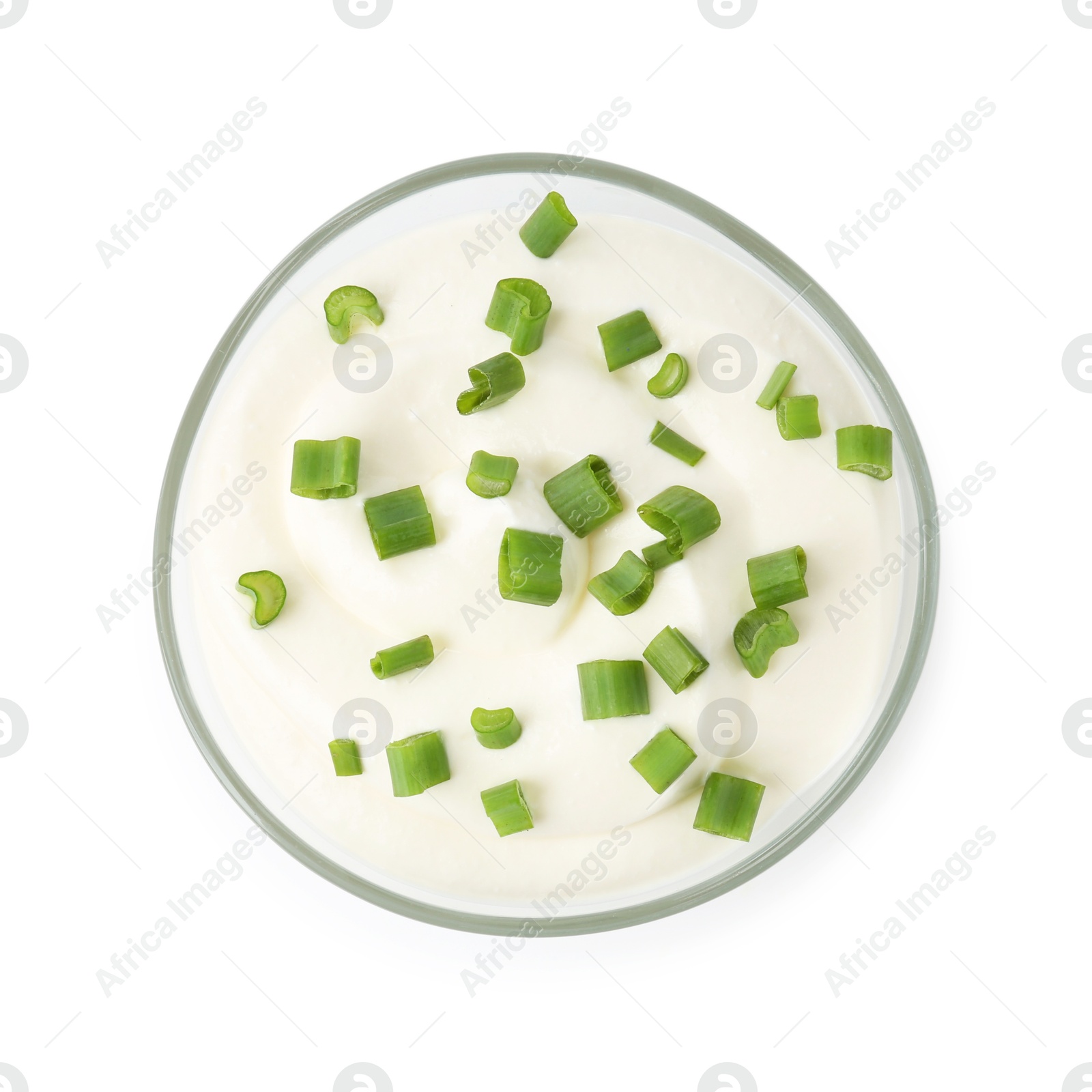 Photo of Delicious yogurt with green onions in bowl isolated on white, top view