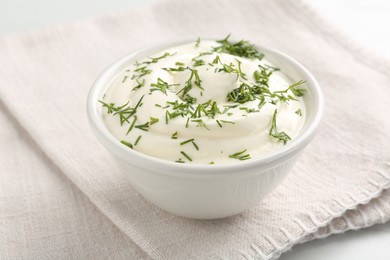 Photo of Delicious yogurt in bowl and dill on table, closeup