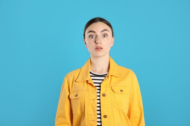 Photo of Portrait of shocked woman on light blue background
