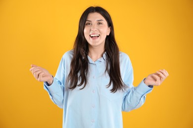 Photo of Portrait of surprised woman on orange background