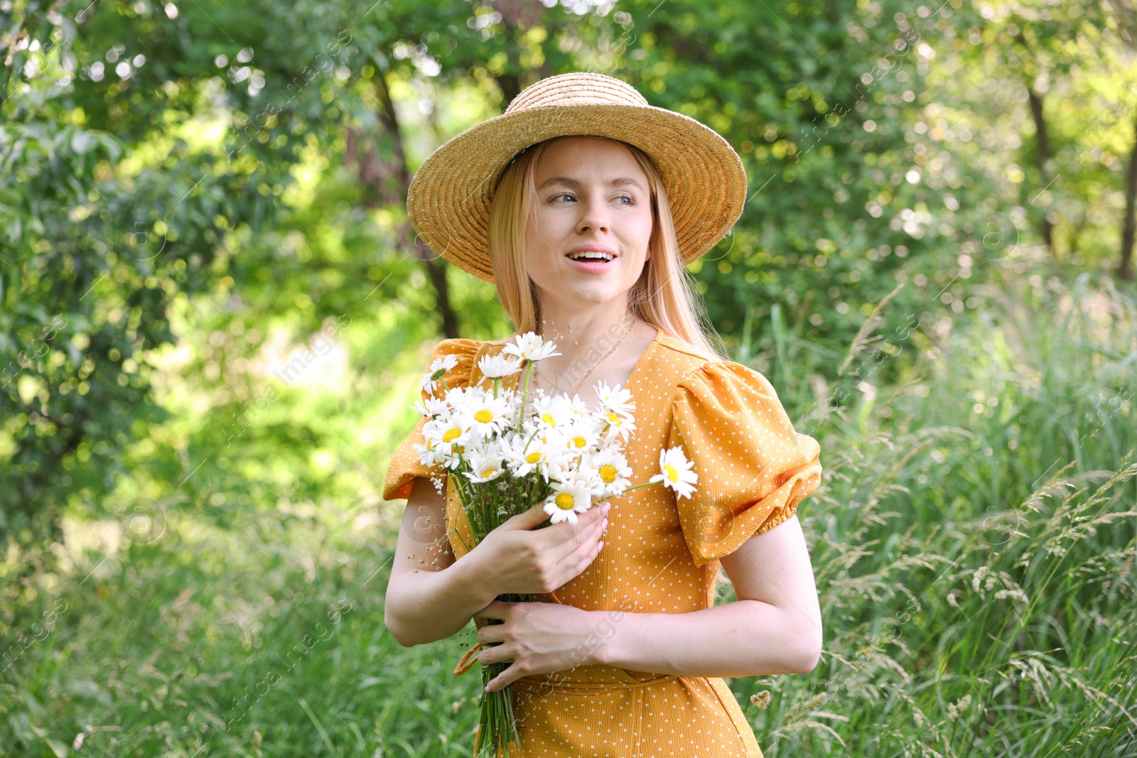 Beautiful woman with bouquet of wildflowers in forest Photo of Beautiful woman with bouquet of wildflowers in forest