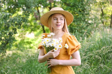 Photo of Beautiful woman with bouquet of wildflowers in forest