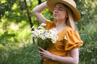 Photo of Beautiful woman with bouquet of wildflowers in forest
