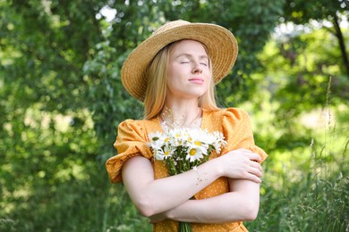 Photo of Beautiful woman with bouquet of wildflowers in forest