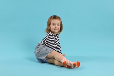 Photo of Cute little girl on light blue background
