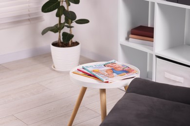 Photo of Different trendy magazines on white table indoors