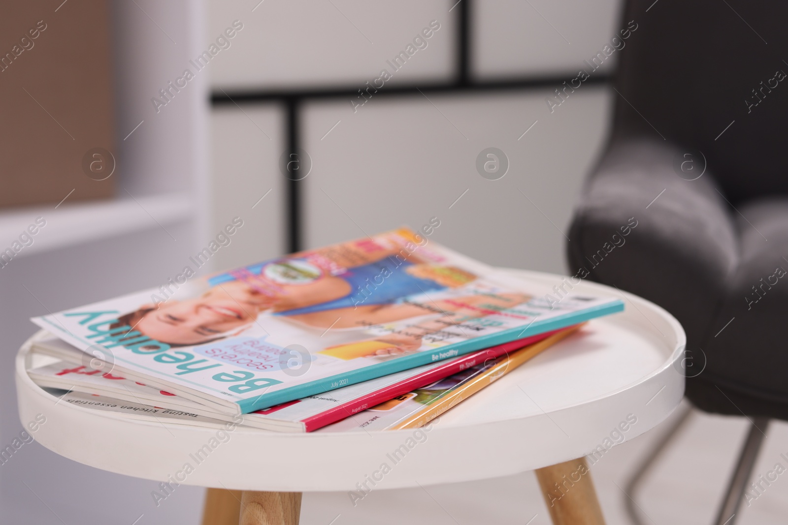 Different trendy magazines on white table indoors, closeup Photo of Different trendy magazines on white table indoors, closeup