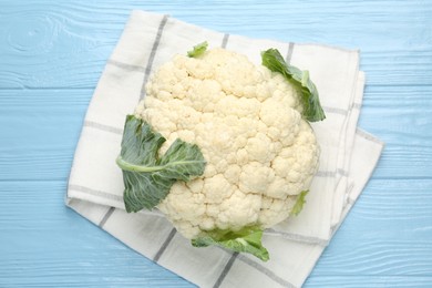 Photo of Whole cauliflower on light blue wooden table, top view
