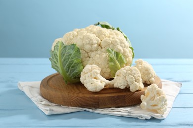 Photo of Raw cauliflower on light blue wooden table