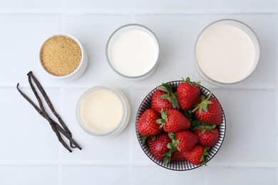 Photo of Different ingredients for panna cotta. Milk, sugar, vanilla and strawberries on white tiled table, flat lay