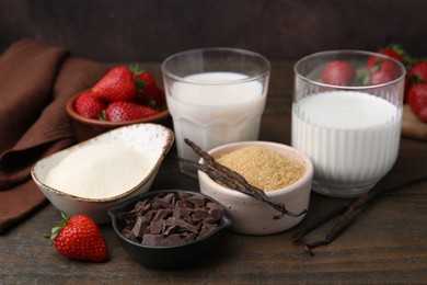 Photo of Different ingredients for panna cotta. Milk, sugar, vanilla, chocolate and strawberries on wooden table, closeup